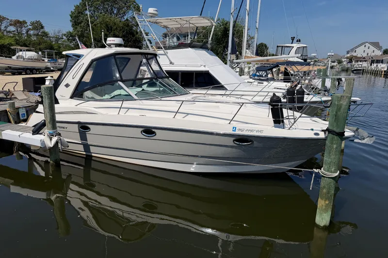 Slide: The Image of 2009 Monterey 340 Sport Yacht docked at marina, clear sky background. - 7