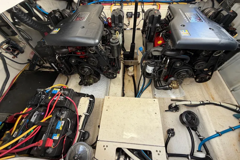 Slide: The Image of Engine compartment of a 2009 Monterey 340 Sport Yacht, showcasing dual engines and wiring. - 50