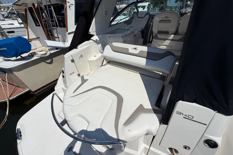 Slide: The Image of 2009 Monterey 340 Sport Yacht interior with seating and helm, docked at marina. - 16