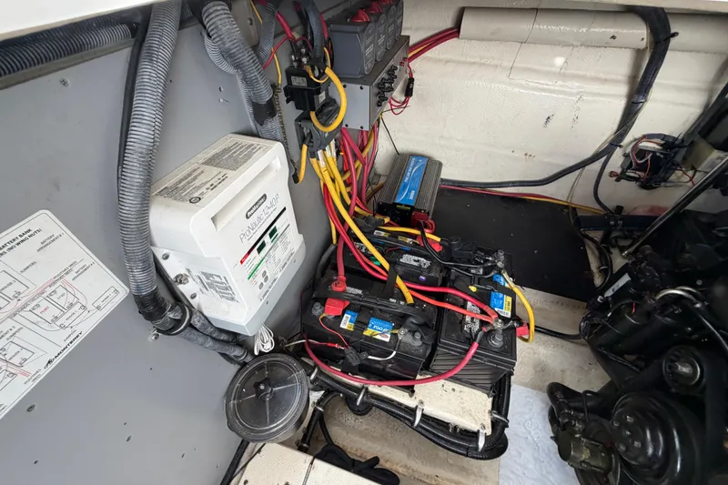Slide: The Image of Engine compartment of a 2009 Monterey 340 Sport Yacht with batteries and wiring. - 54