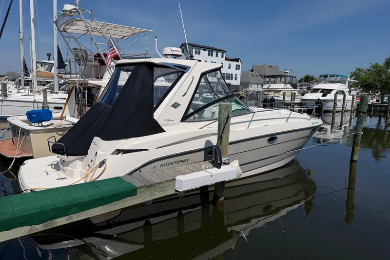 Slide: The Image of 2009 Monterey 340 Sport Yacht docked at a marina, surrounded by other boats. - 9