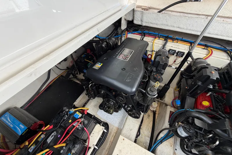 Slide: The Image of Engine compartment of a 2009 Monterey 340 Sport Yacht, showcasing mechanical components and wiring. - 48