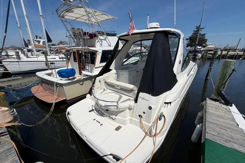 Slide: The Image of 2009 Monterey 340 Sport Yacht docked at a marina, featuring sleek design and American flag. - 38