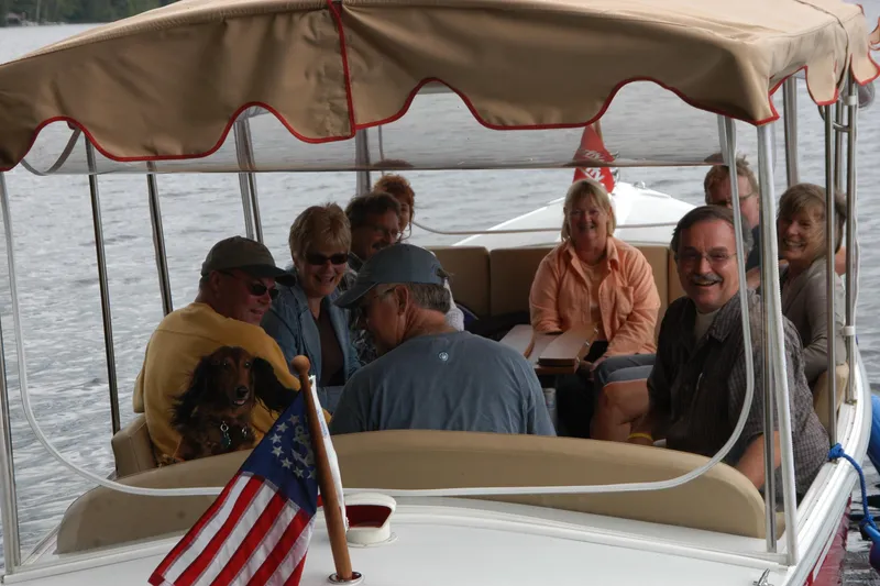 Slide: The Image of Group enjoying a boat ride on a 2004 Duffy 21 Classic with a dog and American flag. - 12