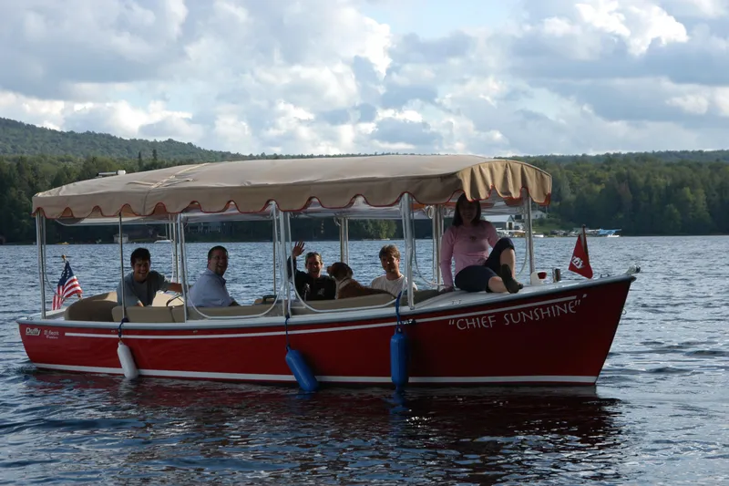 Slide: The Image of Red 2004 Duffy 21 Classic boat named "Chief Sunshine" on a lake with passengers. - 13
