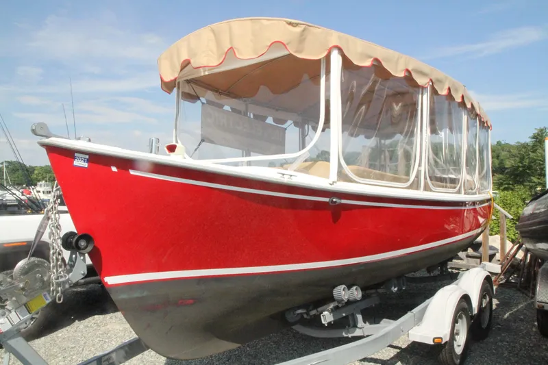 Slide: The Image of Red 2004 Duffy 21 Classic boat on trailer, with beige canopy and clear side panels. - 2