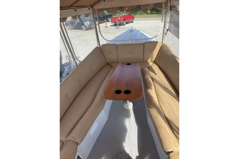 Slide: The Image of Interior of a 2004 Duffy 21 Classic boat with beige seating and wooden table. - 6