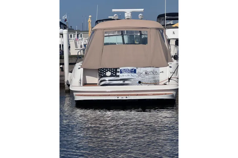 Slide: The Image of 2000 Sea Ray 410 Express Cruiser docked at marina, rear view with cover. - 5