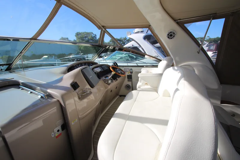 Slide: The Image of Interior view of 2000 Sea Ray 410 Express Cruiser cockpit with white seating and control panel. - 10