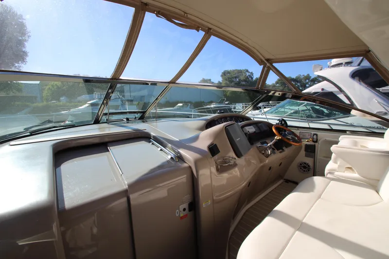 Slide: The Image of Interior view of a 2000 Sea Ray 410 Express Cruiser cockpit with steering wheel and seating. - 11