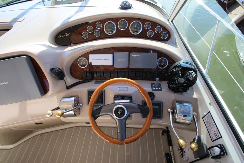 Slide: The Image of Dashboard of a 2000 Sea Ray 410 Express Cruiser with steering wheel and controls. - 12