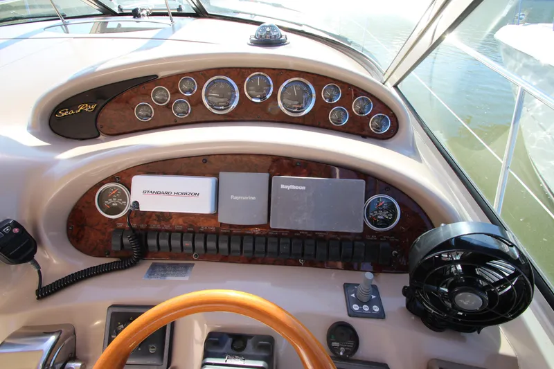 Slide: The Image of Cockpit dashboard of a 2000 Sea Ray 410 Express Cruiser with navigation instruments. - 13