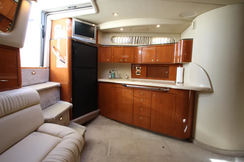 Slide: The Image of Luxurious interior of a 2000 Sea Ray 410 Express Cruiser with elegant wood cabinetry. - 16
