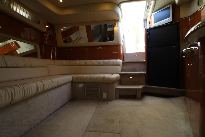 Slide: The Image of Interior of 2000 Sea Ray 410 Express Cruiser with beige seating and steps. - 18