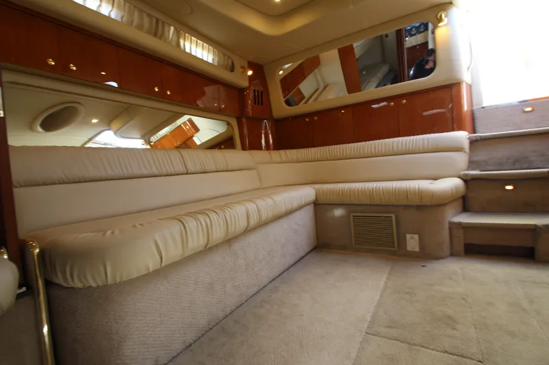 Slide: The Image of Luxurious interior of a 2000 Sea Ray 410 Express Cruiser with plush seating and elegant wood finishes. - 19