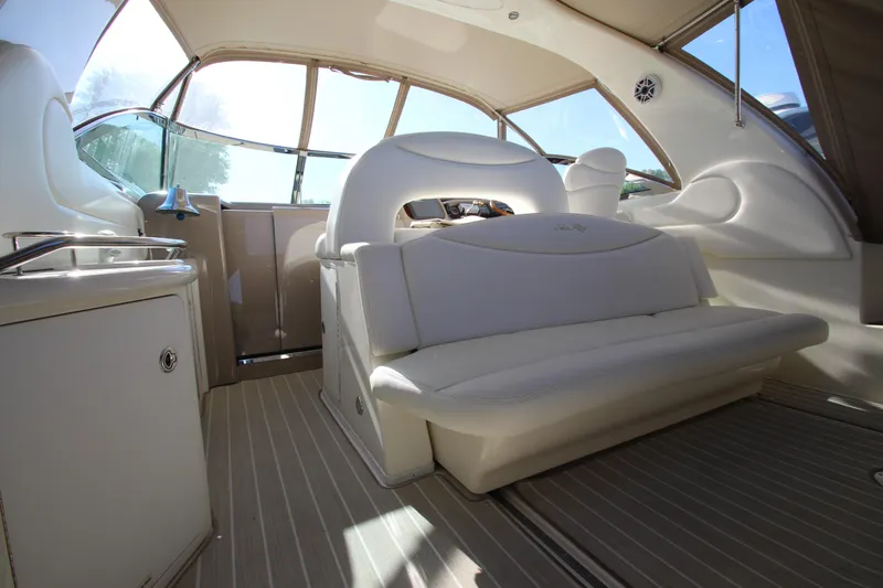 Slide: The Image of Interior of 2000 Sea Ray 410 Express Cruiser with white seating and sleek design. - 2