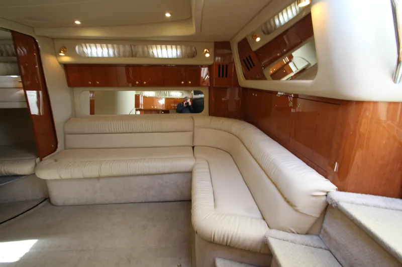 Slide: The Image of Luxurious interior of 2000 Sea Ray 410 Express Cruiser with plush seating and wood accents. - 20
