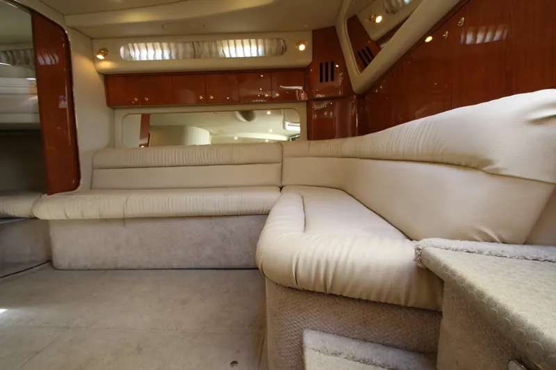Slide: The Image of Interior of 2000 Sea Ray 410 Express Cruiser with beige seating and wooden accents. - 21