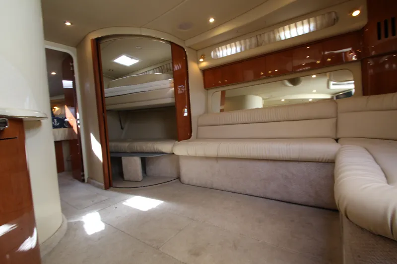 Slide: The Image of Interior of 2000 Sea Ray 410 Express Cruiser with beige seating and wood accents. - 22