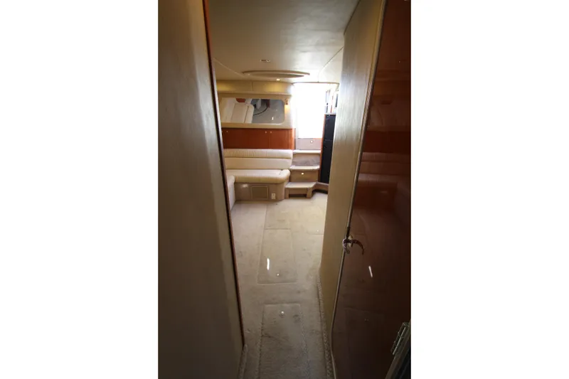 Slide: The Image of Interior of 2000 Sea Ray 410 Express Cruiser, featuring cozy seating and elegant wood finishes. - 29