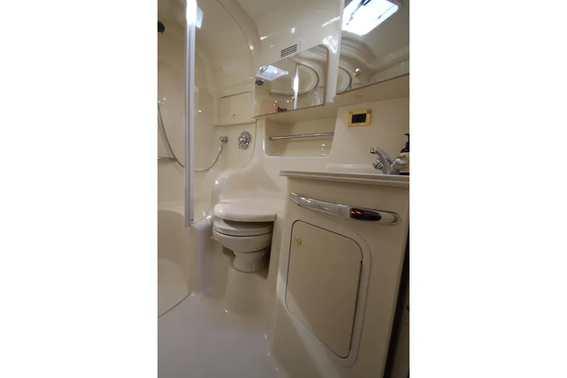 Slide: The Image of Bathroom interior of 2000 Sea Ray 410 Express Cruiser, featuring toilet and sink. - 32