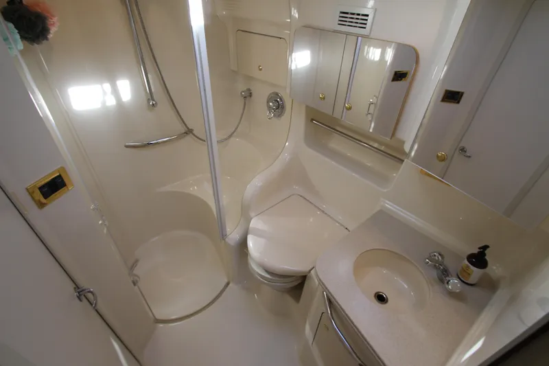 Slide: The Image of Bathroom interior of 2000 Sea Ray 410 Express Cruiser with shower, sink, and toilet. - 33