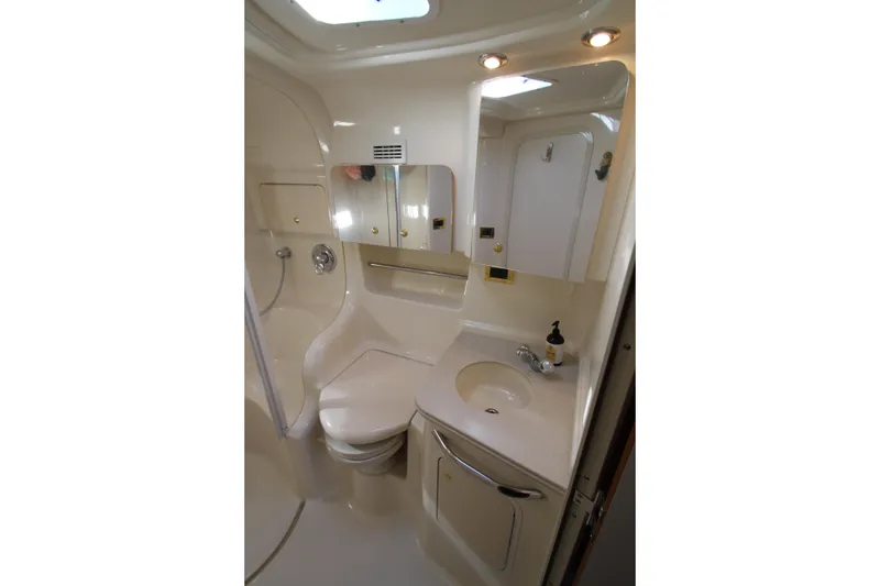 Slide: The Image of Bathroom interior of 2000 Sea Ray 410 Express Cruiser with sink, mirror, and shower. - 34