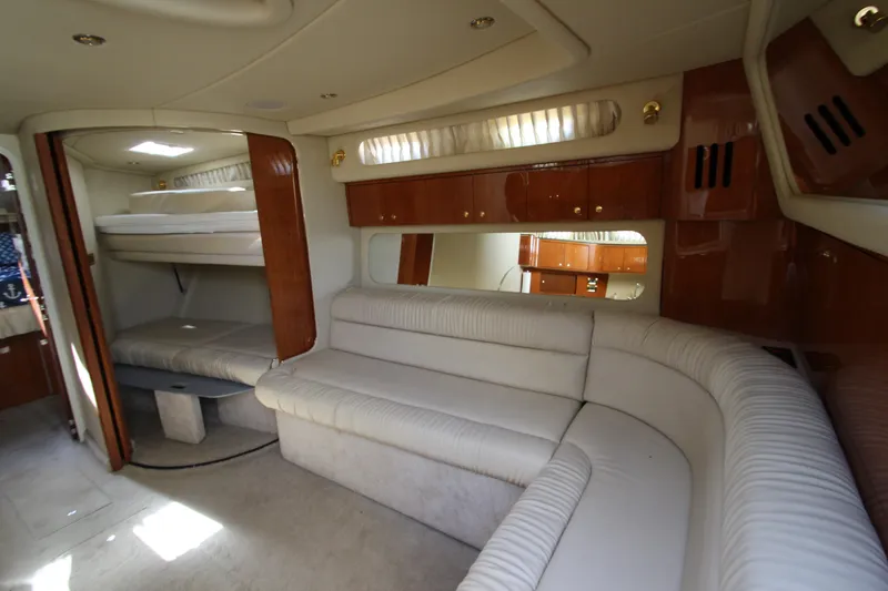 Slide: The Image of Interior of 2000 Sea Ray 410 Express Cruiser with plush seating and wood accents. - 39
