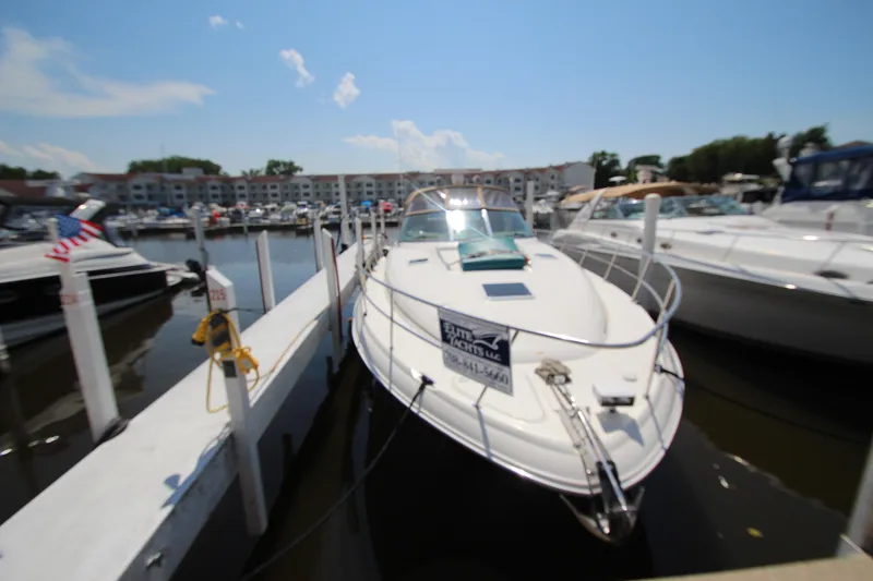 Slide: The Image of 2000 Sea Ray 410 Express Cruiser docked at marina under clear blue sky. - 1