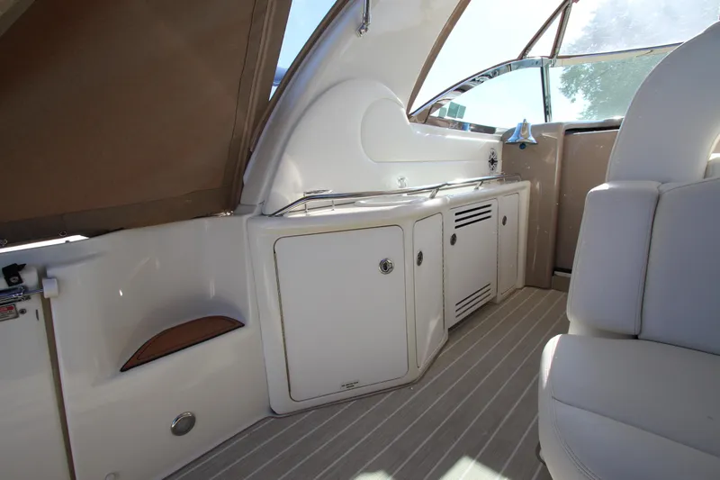 Slide: The Image of Interior view of a 2000 Sea Ray 410 Express Cruiser, featuring sleek cabinetry and seating. - 4