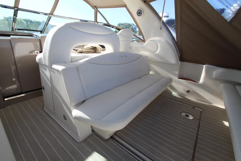 Slide: The Image of Interior of 2000 Sea Ray 410 Express Cruiser with white seating and wood flooring. - 42