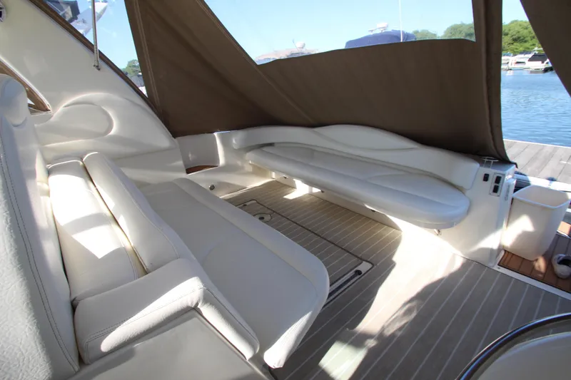 Slide: The Image of Interior of 2000 Sea Ray 410 Express Cruiser with white seating and brown canopy. - 43