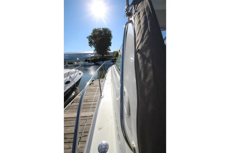 Slide: The Image of 2000 Sea Ray 410 Express Cruiser docked under bright sun. - 44