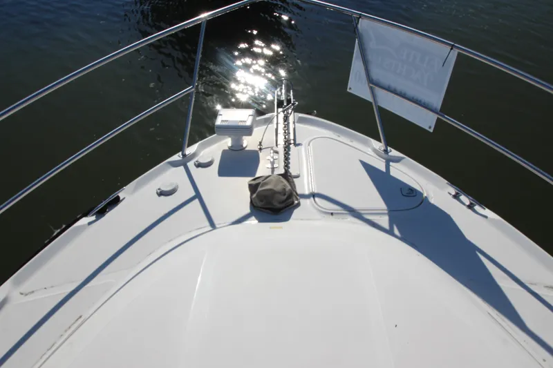 Slide: The Image of Bow view of 2000 Sea Ray 410 Express Cruiser on calm water. - 46