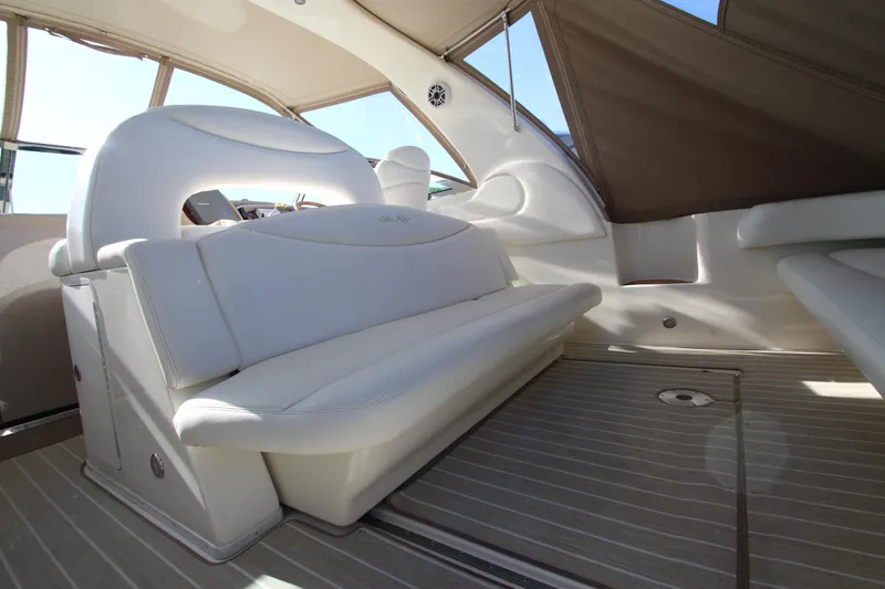 Slide: The Image of Luxurious interior of 2000 Sea Ray 410 Express Cruiser with white seating and sleek design. - 5