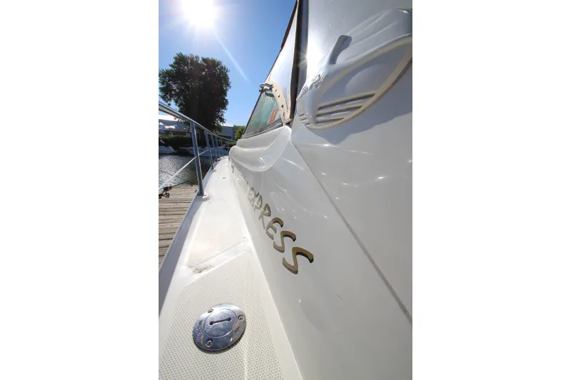 Slide: The Image of 2000 Sea Ray 410 Express Cruiser docked under bright sunlight. - 51