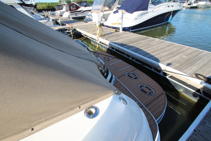 Slide: The Image of 2000 Sea Ray 410 Express Cruiser docked at marina with wooden deck. - 52