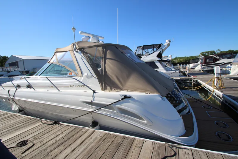Slide: The Image of Sea Ray 410 Express Cruiser 2000 docked at marina under clear blue sky. - 53
