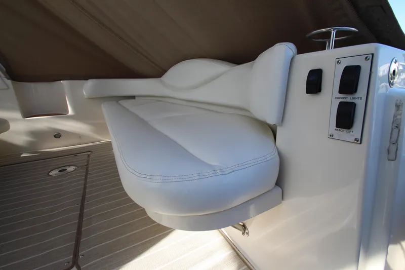 Slide: The Image of White seat and control panel on 2000 Sea Ray 410 Express Cruiser boat. - 6