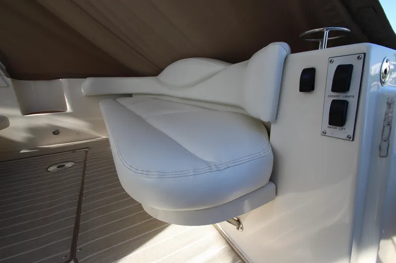 Slide: The Image of White seat and control panel on a 2000 Sea Ray 410 Express Cruiser yacht. - 7