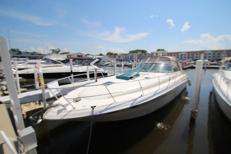 Slide: The Image of 2000 Sea Ray 410 Express Cruiser docked at marina under clear blue sky. - 3