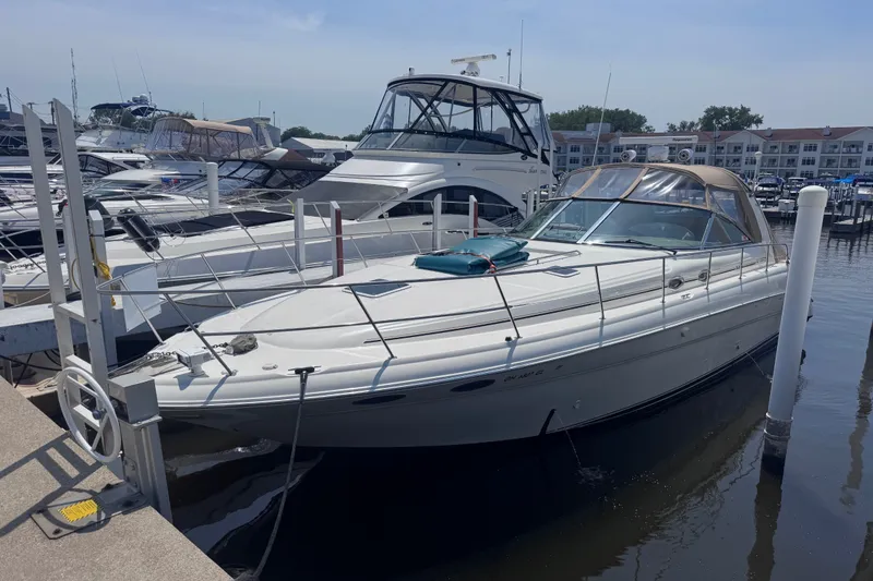 Slide: The Image of 2000 Sea Ray 410 Express Cruiser docked at marina, surrounded by other boats. - 3