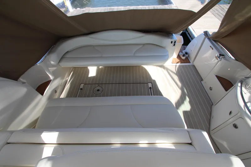 Slide: The Image of Interior of 2000 Sea Ray 410 Express Cruiser with white seating and wood accents. - 9