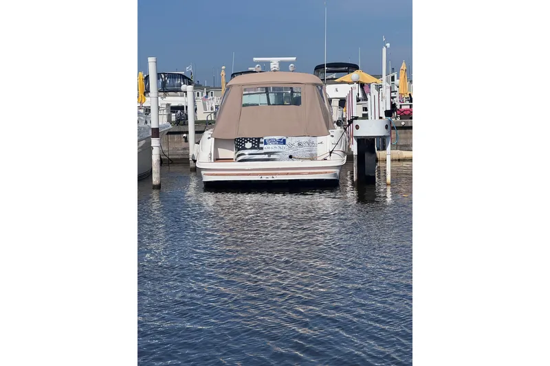 Slide: The Image of 2000 Sea Ray 410 Express Cruiser docked at marina, rear view. - 4