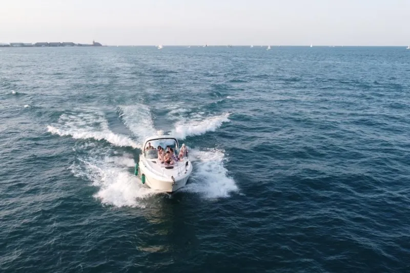 Slide: The Image of 2008 Sea Ray 350 Sundancer cruising on open water with passengers enjoying the ride. - 5