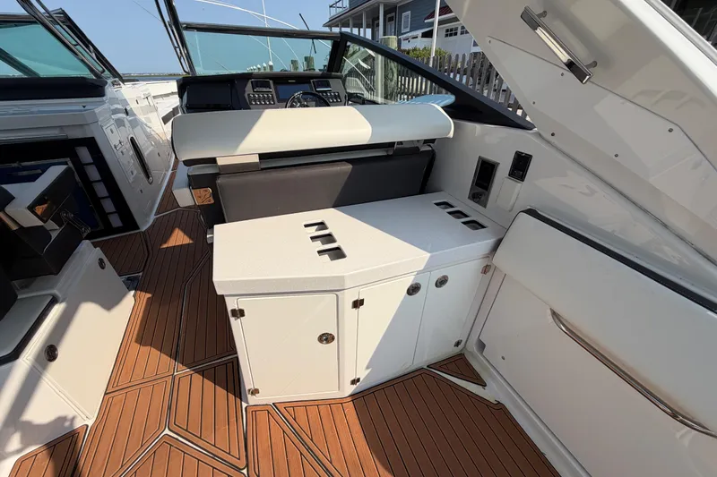 Slide: The Image of 2017 Monterey 378SE Super Express boat interior with sleek seating and wooden flooring. - 13