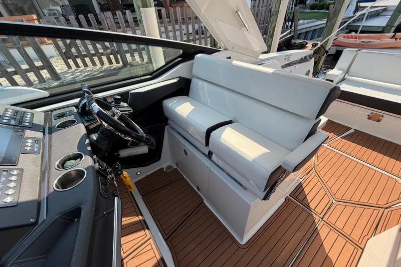 Slide: The Image of 2017 Monterey 378SE Super Express boat interior with sleek helm and white seating. - 19