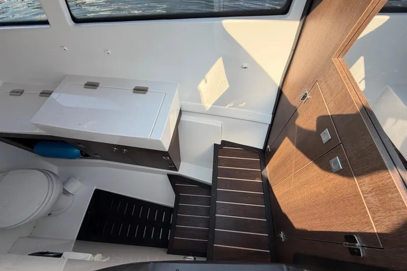 Slide: The Image of Interior of 2017 Monterey 378SE Super Express boat with wooden cabinetry and compact bathroom. - 38