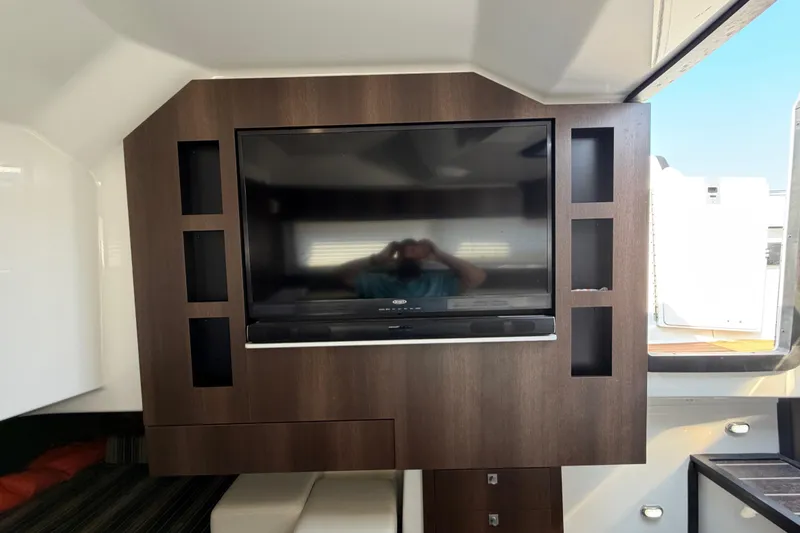 Slide: The Image of Interior of 2017 Monterey 378SE Super Express with mounted TV and wooden cabinetry. - 35