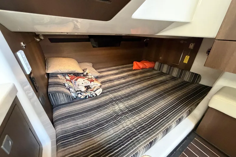 Slide: The Image of Cozy cabin interior of 2017 Monterey 378SE Super Express with striped bedding. - 36